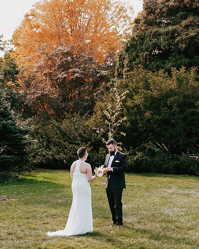 couple exhcanging vows in a field