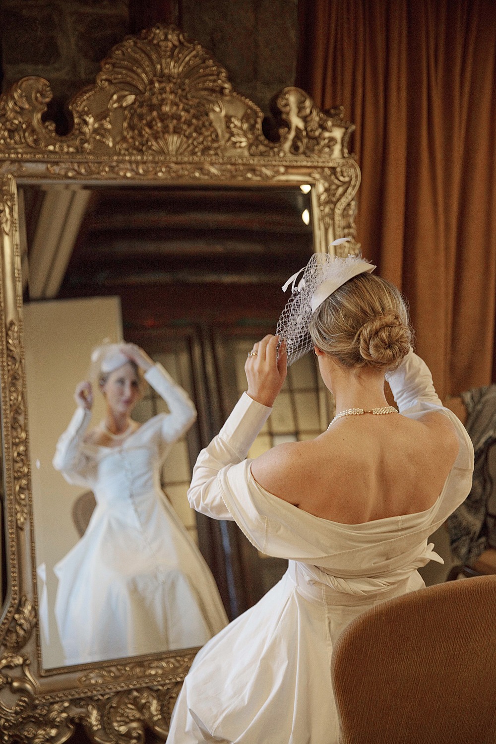 Bride adjusting her veil in front of a golden mirror Montebello-wedding-photographer-Eva-Hadhazy-Photography