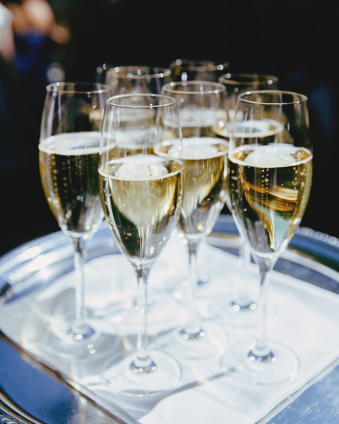 Documentary wedding photographer Eva Hadhazy Champagne flutes filled with champagne on tray