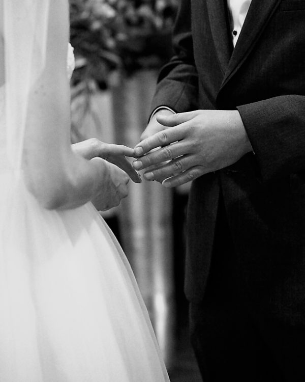 couple is touching each other fingers gently at Museum of Nature