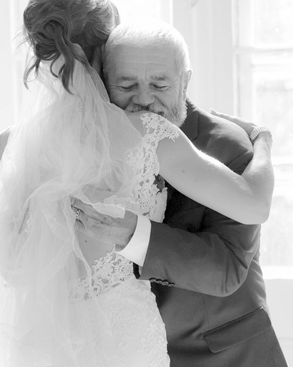 Bride hugging her father during a micro wedding