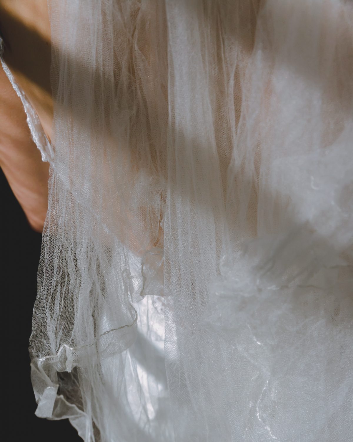 details of a silk veil on bride