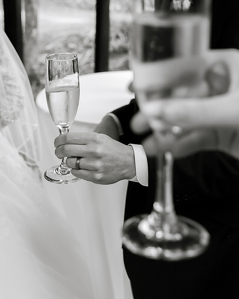 close up of Champagne gallses in hands black and whote image