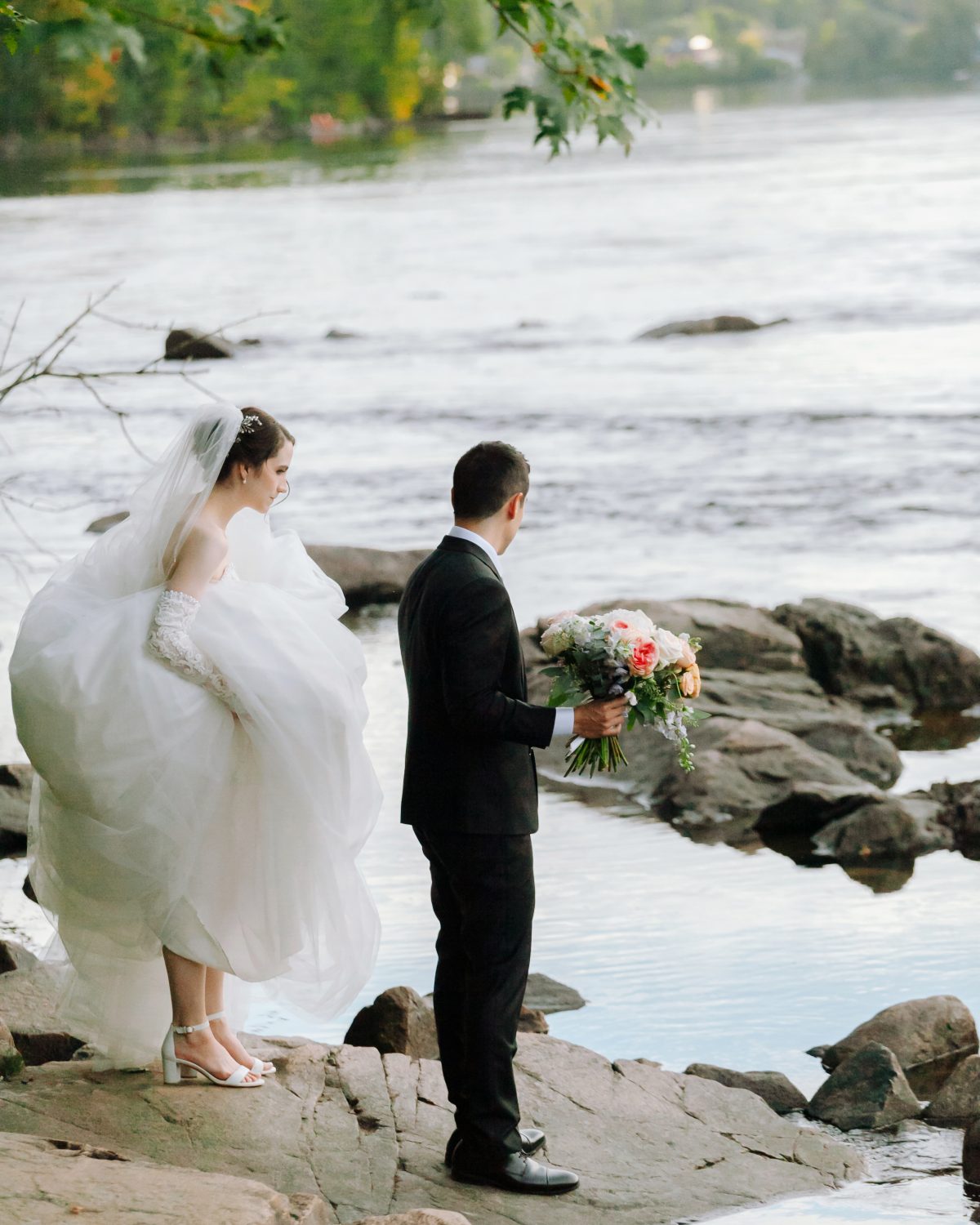 couple is standing and looking at gatineau river at wakefield