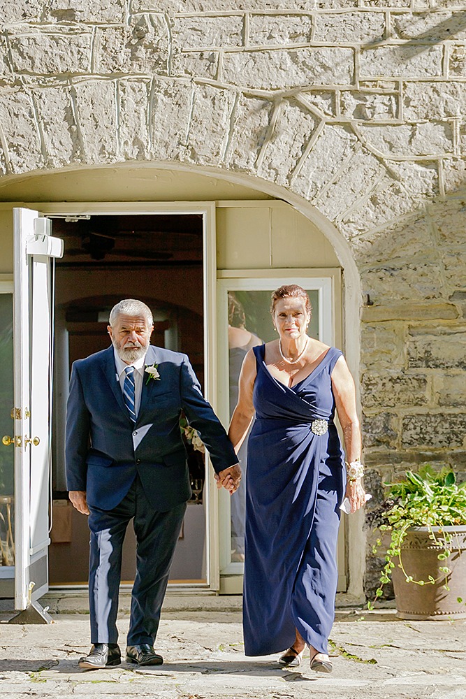 parents holding hands before ceremony
