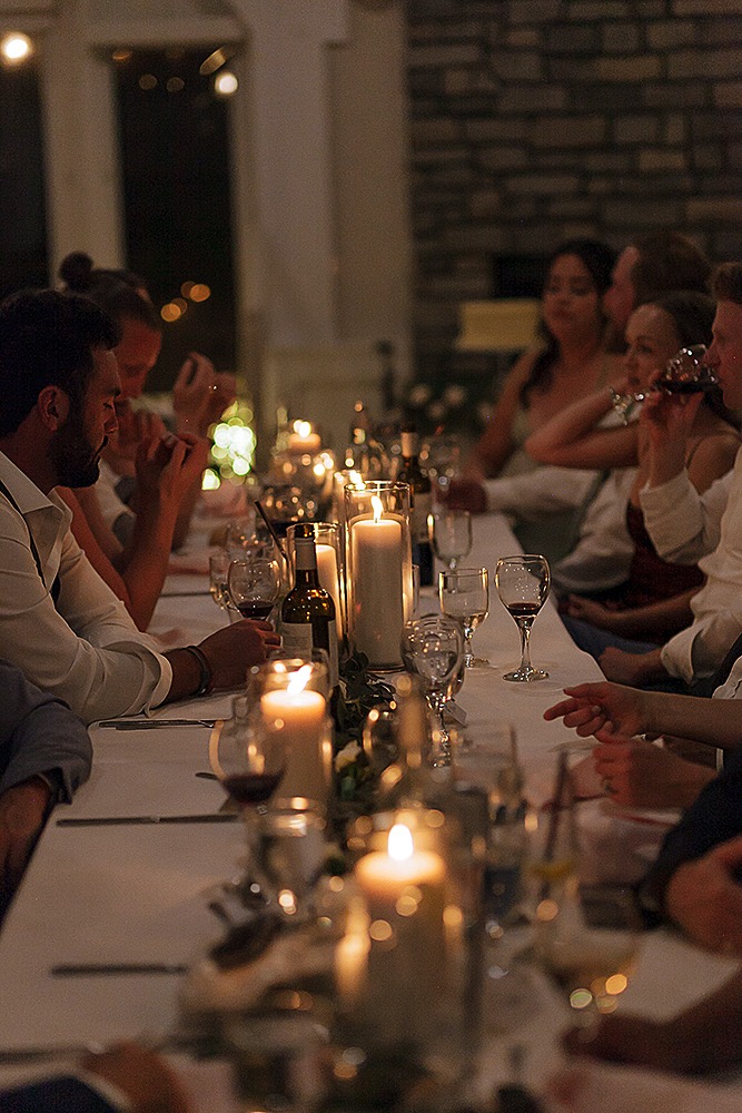 Wedding guests laughing and smiling during the reception at Strathmere’s farmhouse venue.