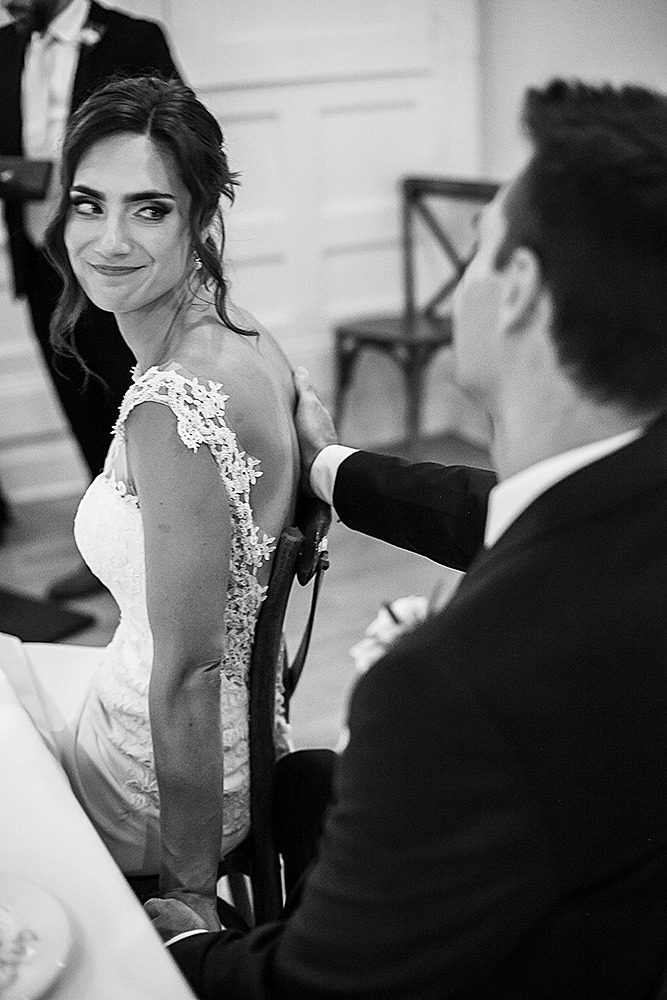 Tender touch and look between a couple during speeches 