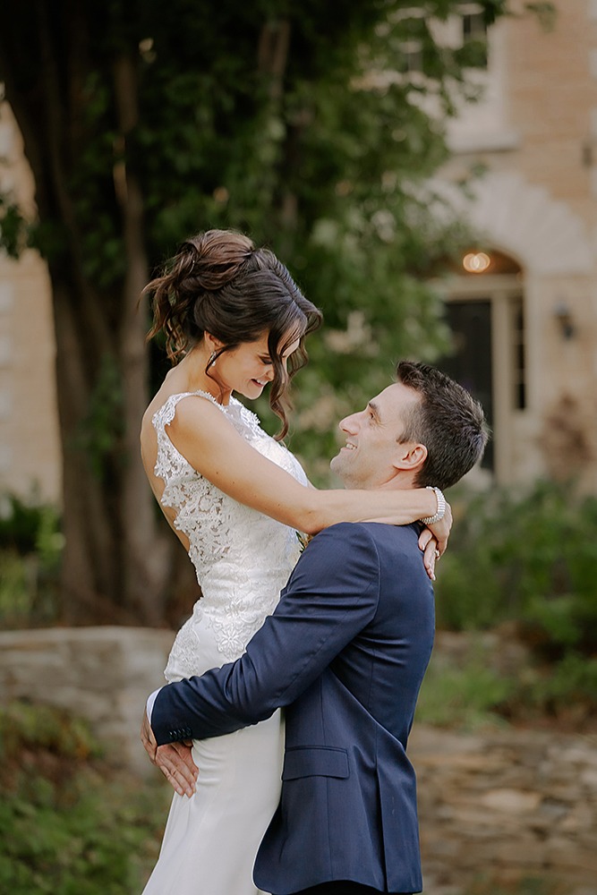 groom lifting the bride in the air