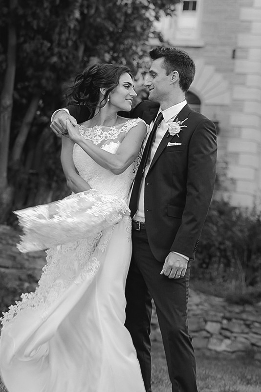 Black and white image of bride and groom sharing their first dance in a timeless, romantic moment