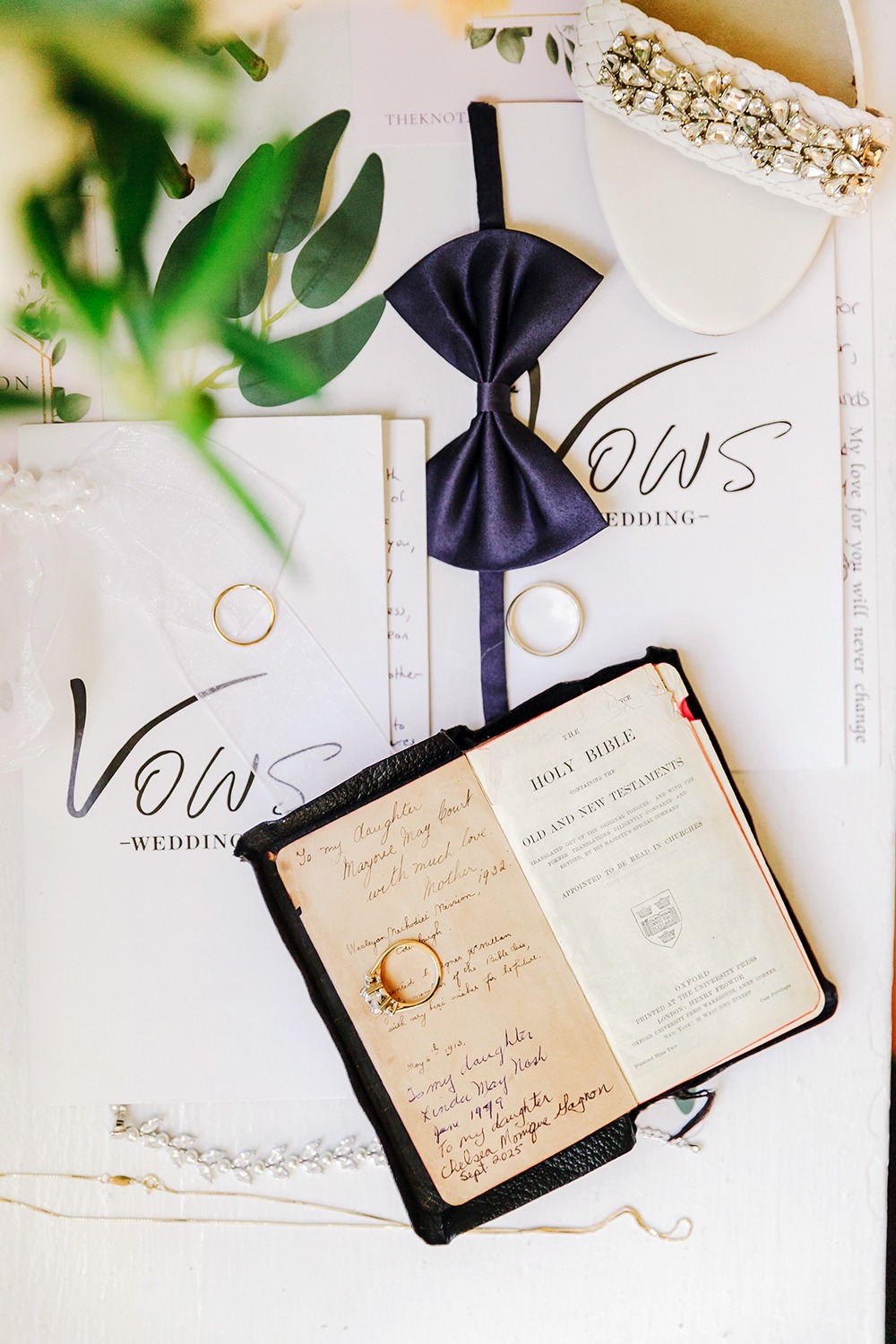 family bible showing all the brides' names and wedding dates, a wedding ring is placed ove this page