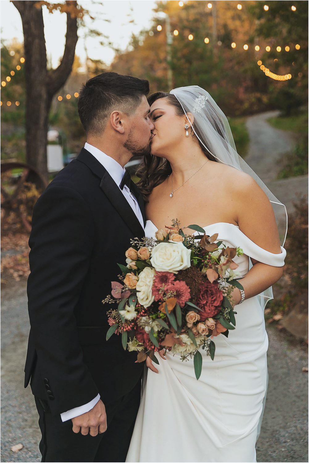 wedding couple kissing in a fall foliage wakefield mill