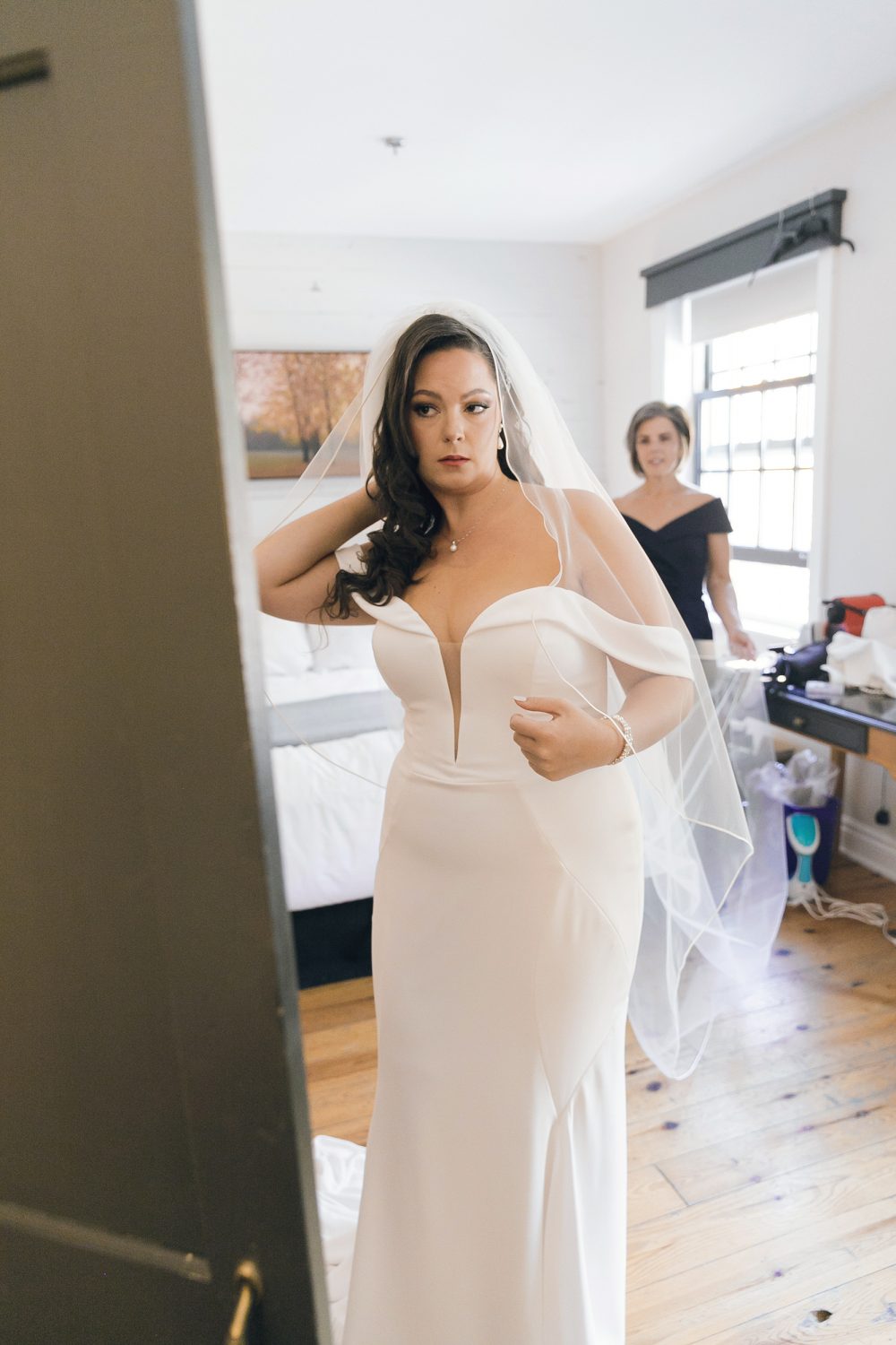 Kristine getting into her wedding dress with help from mom