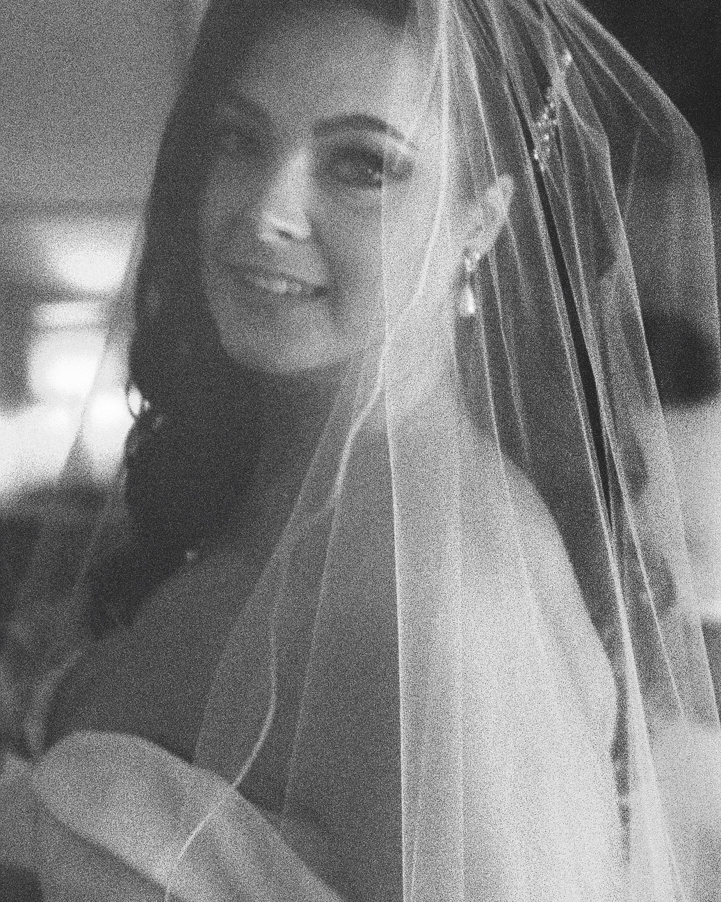 Film photo of Bride is glancing theough the veil