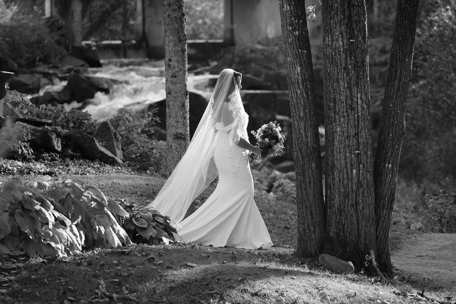 Bride walking down the aisle alone in autumn forest