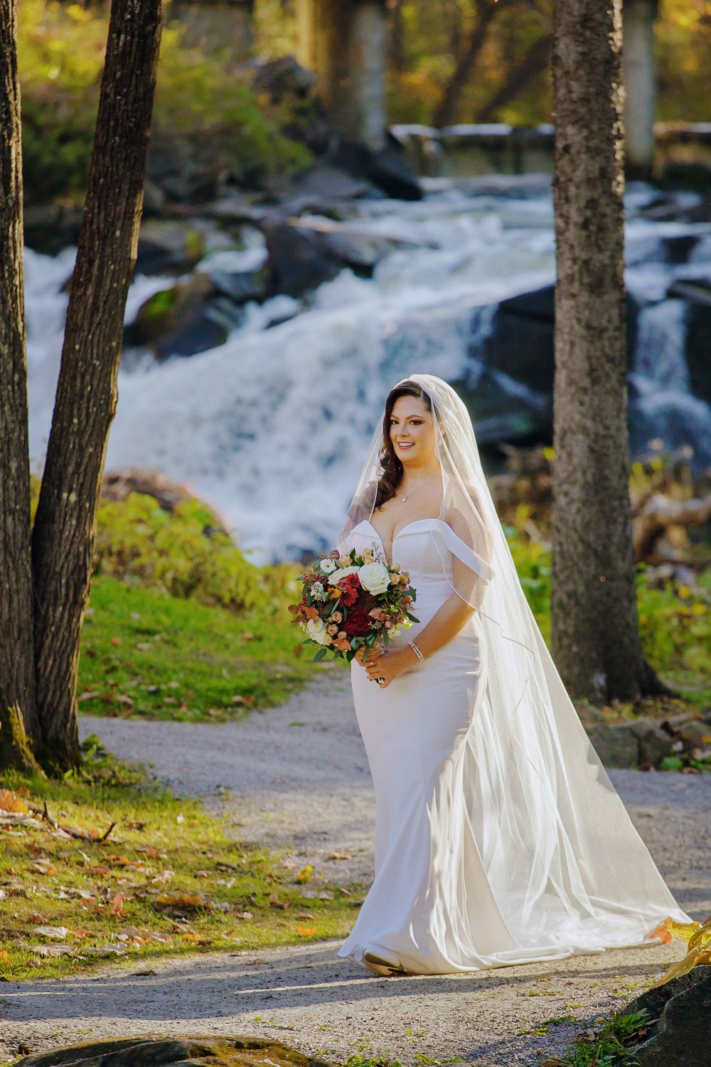 Bride walking down the aisle alone in autumn forest