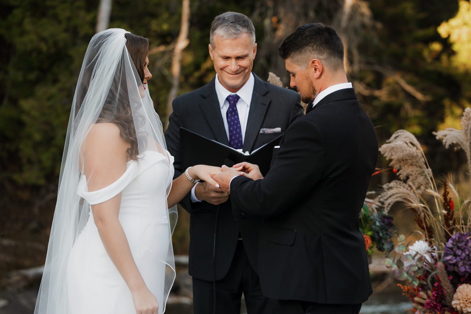 Couple exchanging vows during October wedding