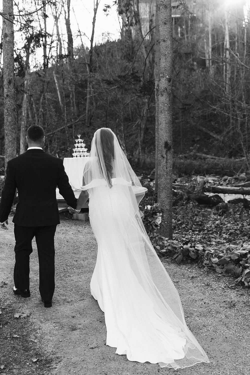 Champagne tower set up in the woods after ceremony
