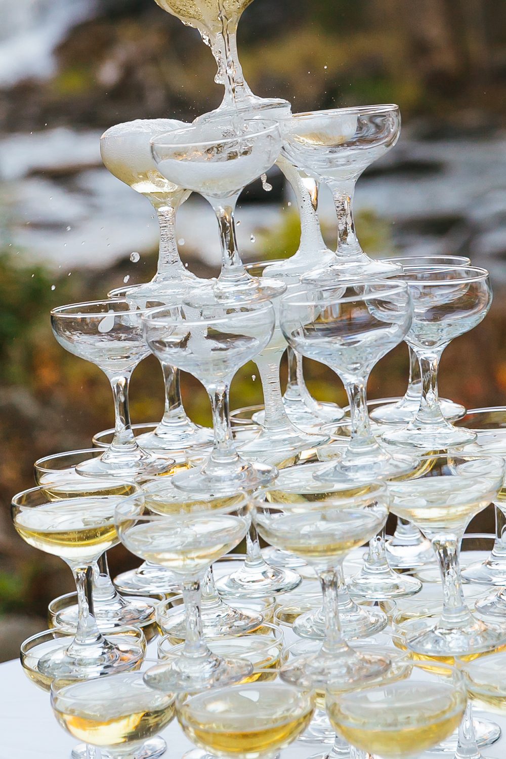 Close-up of champagne glasses clinking