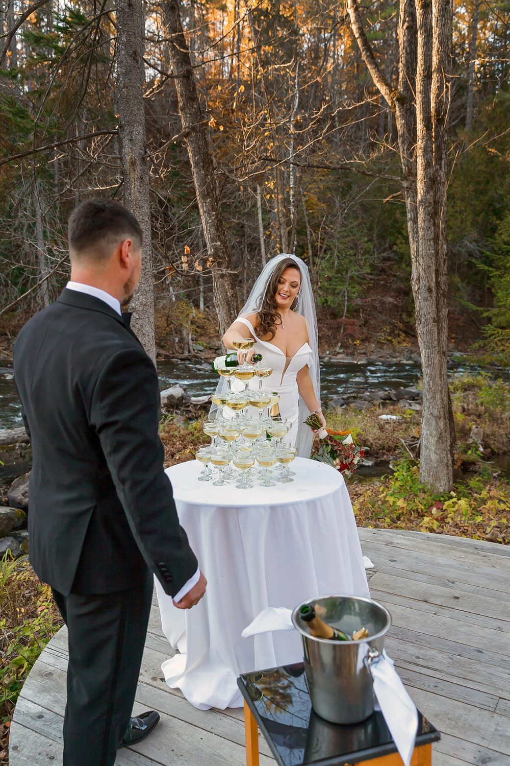 Couple pouring champagne into the glasses