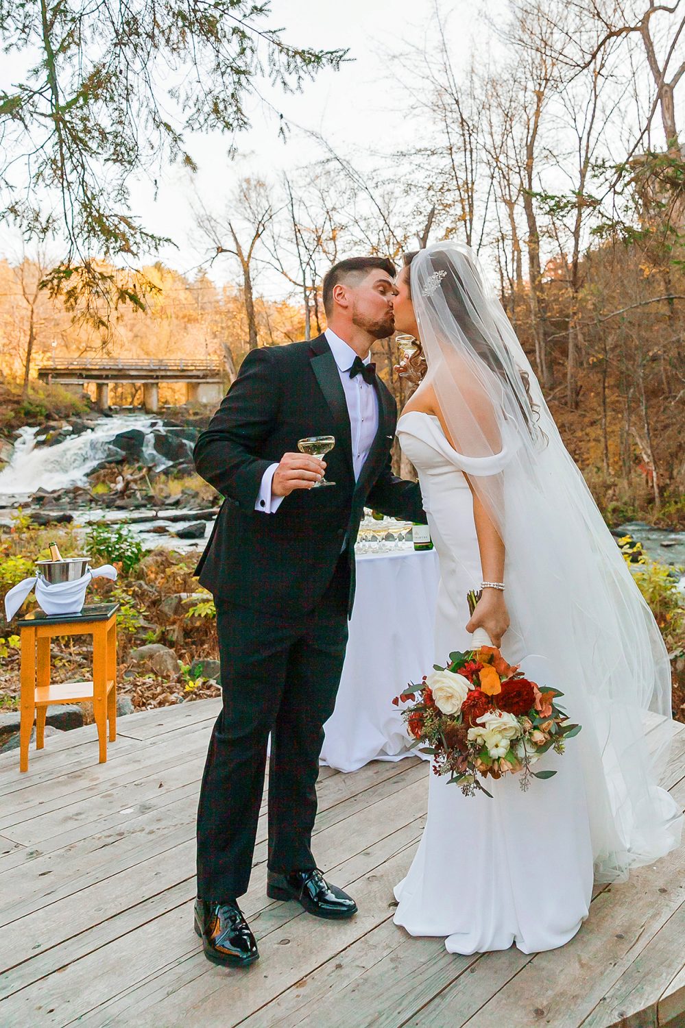 couple kissing after the toast in the woods