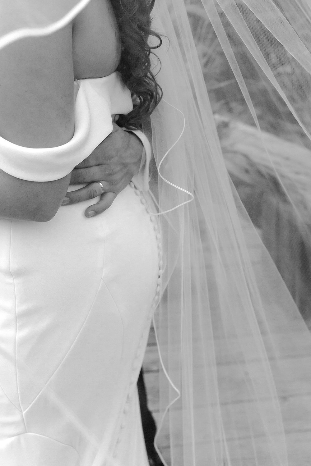 tender touch by groom on brides waiste