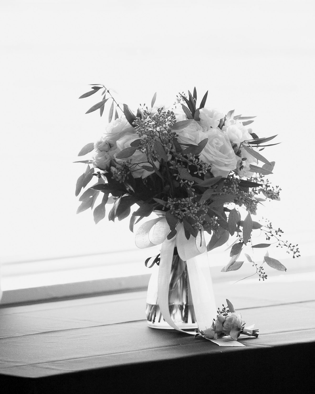 black and photo of bridal boque in the wondow