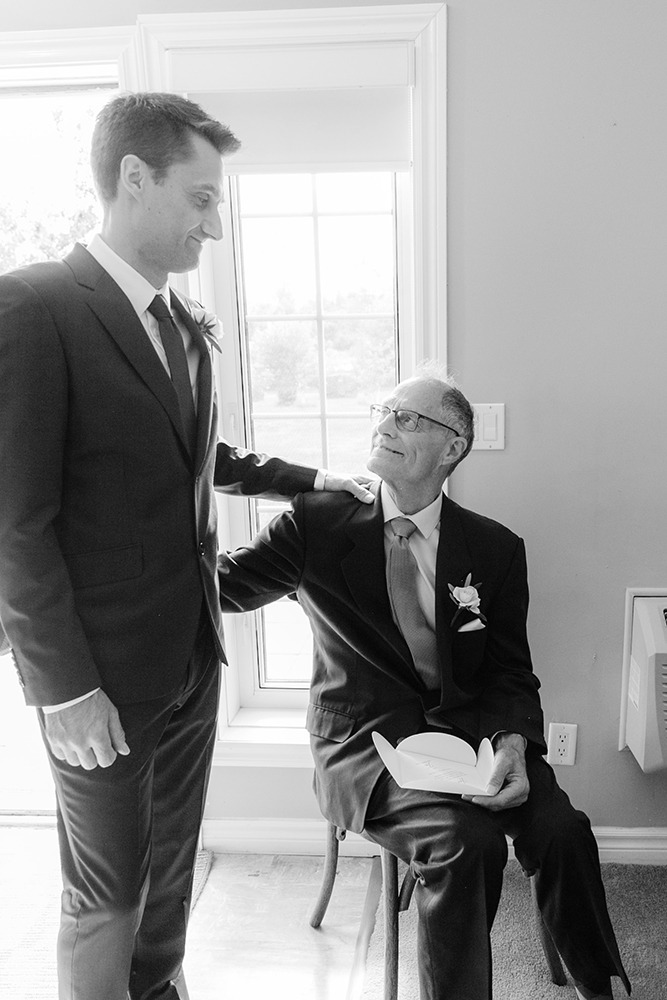 groom and dad gently hugging after present exchange