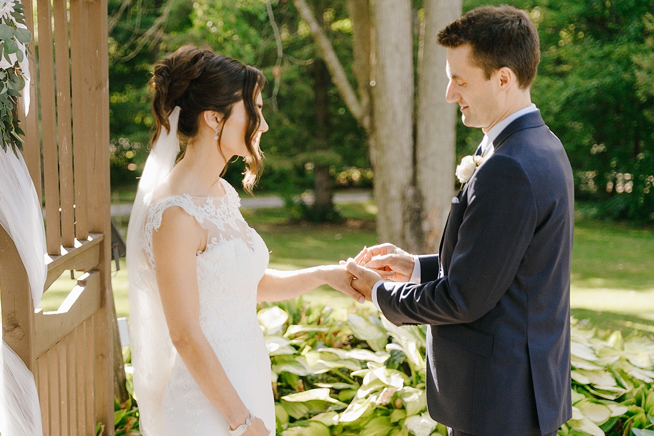 Bride and groom exchanging rings during the wedding ceremony, capturing the moment of commitment and love.