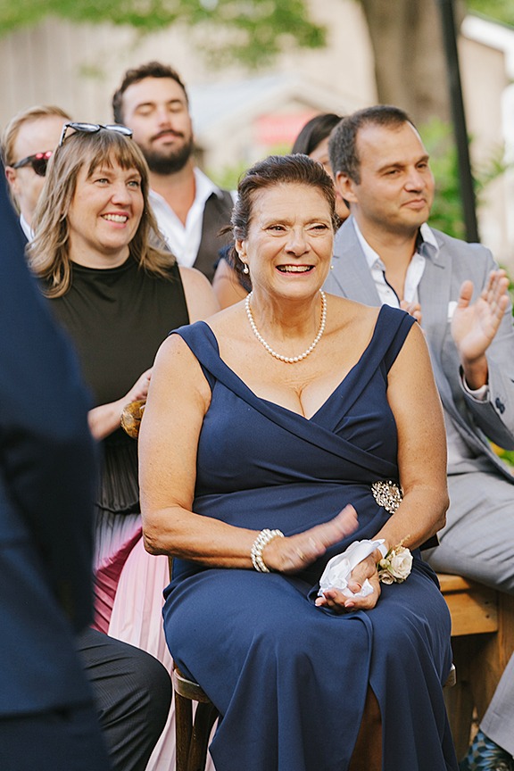 Parents of the bride and groom smiling warmly during the ceremony.