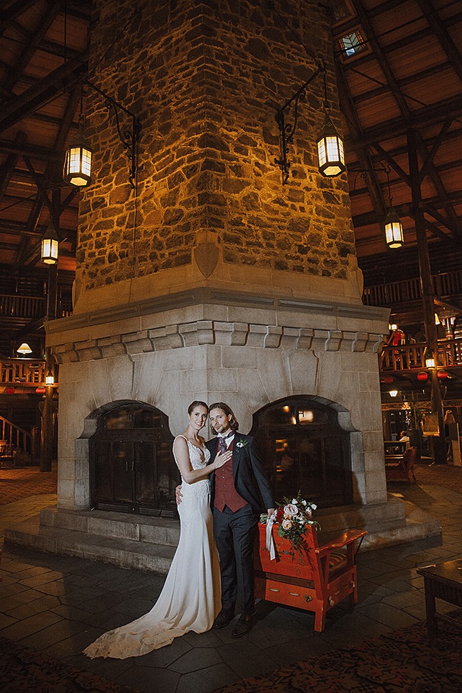 Wedding couple portrait by the iconic fireplace of Chateau Montebello 