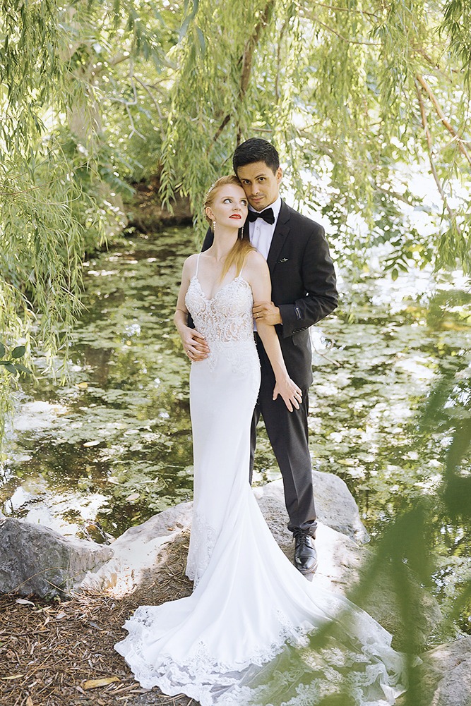 Bride and groom candid portraits among trees in the Ottawa Arboretum