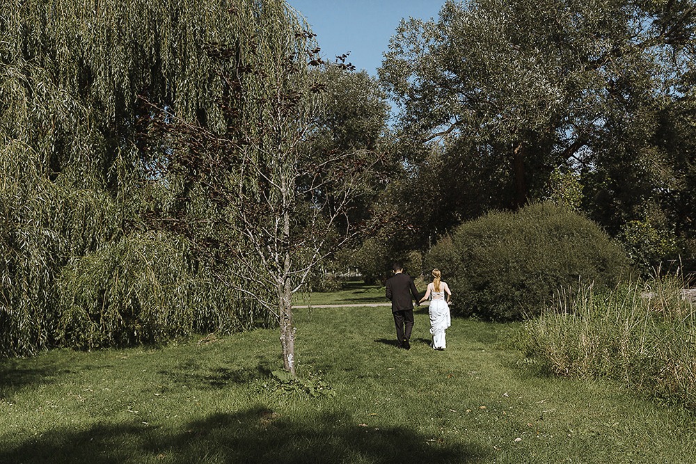 Bride and groom candid portraits among trees in the Ottawa Arboretum