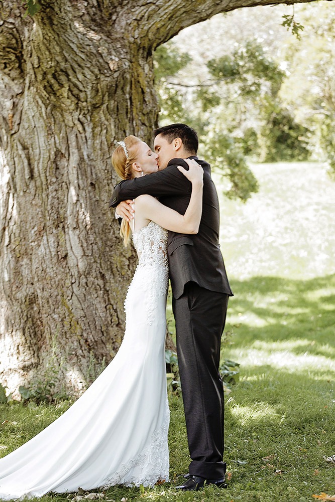 Couple wedding vows under a maple tree at a small outdoor wedding in the Ottawa Arboretum.