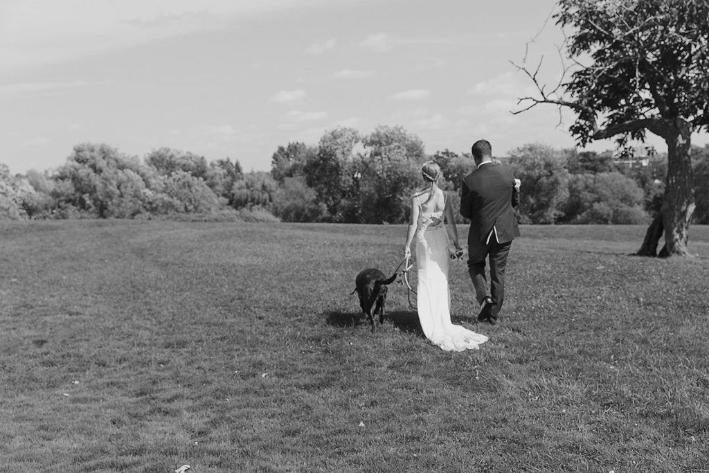 Bride and groom posing for portraits among trees in the Ottawa Arboretum