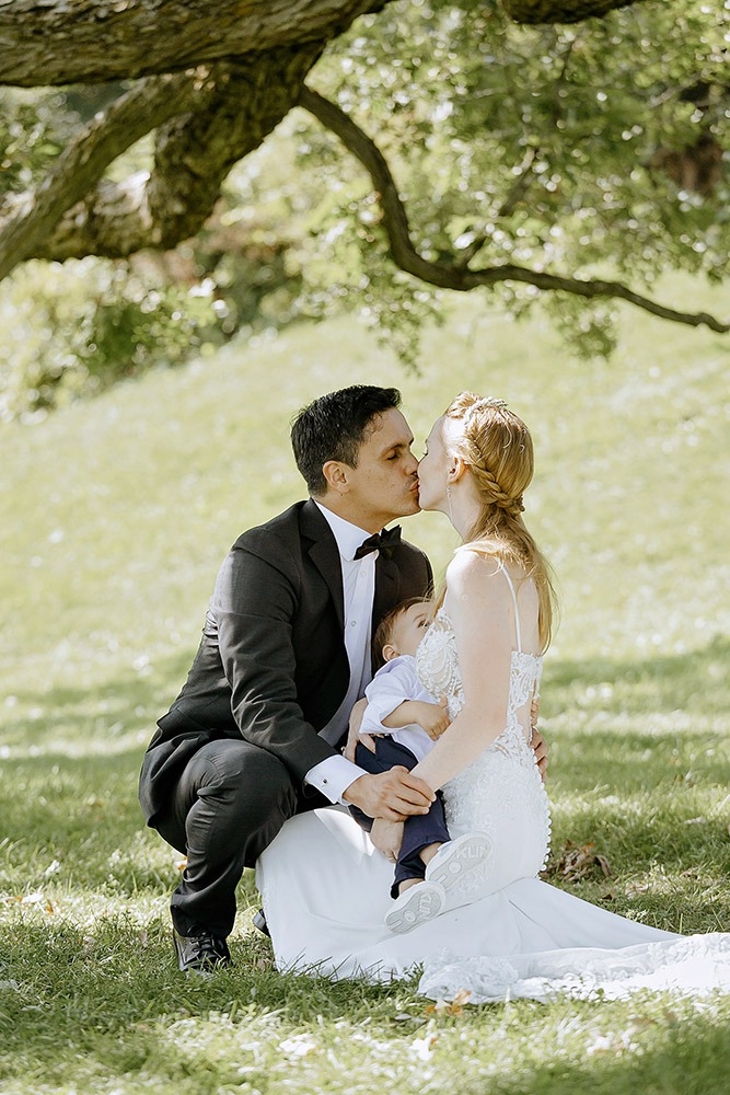 Bride and groom posing for portraits among trees in the Ottawa Arboretum