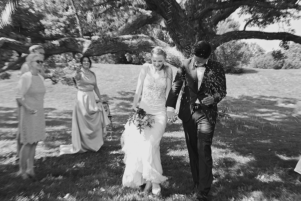 Guests tossing rice over the newlywed couple at the Ottawa Arboretum