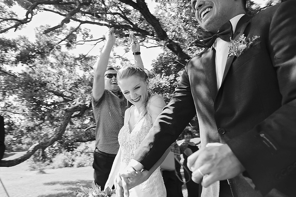Guests tossing rice over the newlywed couple at the Ottawa Arboretum