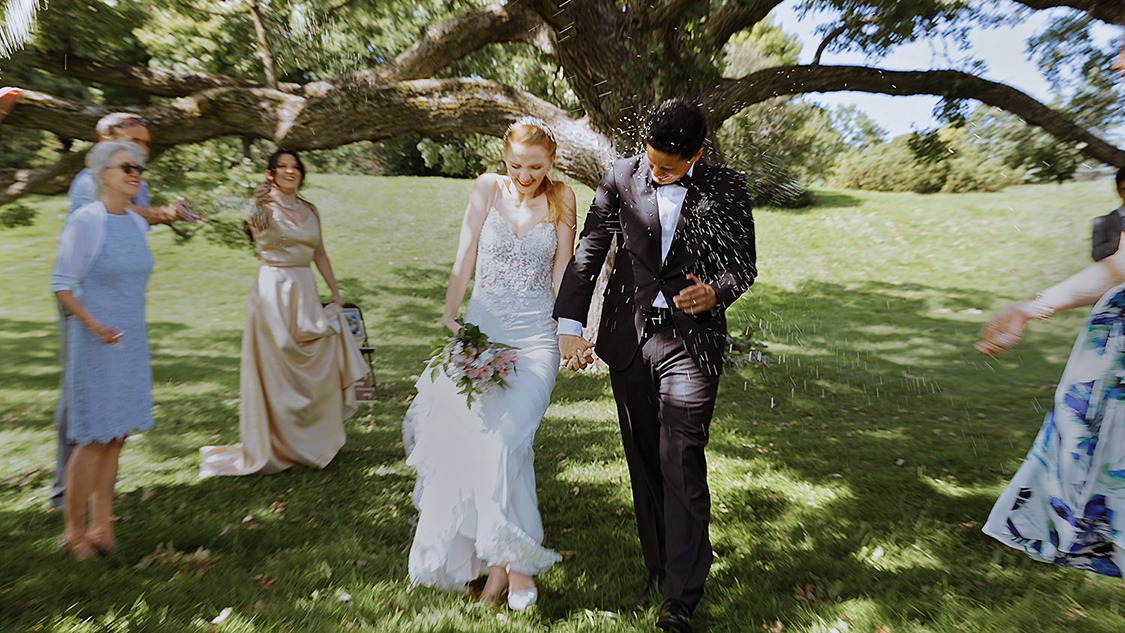 Guests tossing rice over the newlywed couple at the Ottawa Arboretum