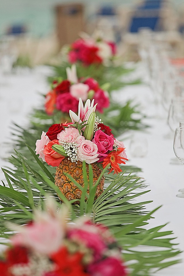 destination teable decor colourful red roses placed in pineapple boides royalton punta cana